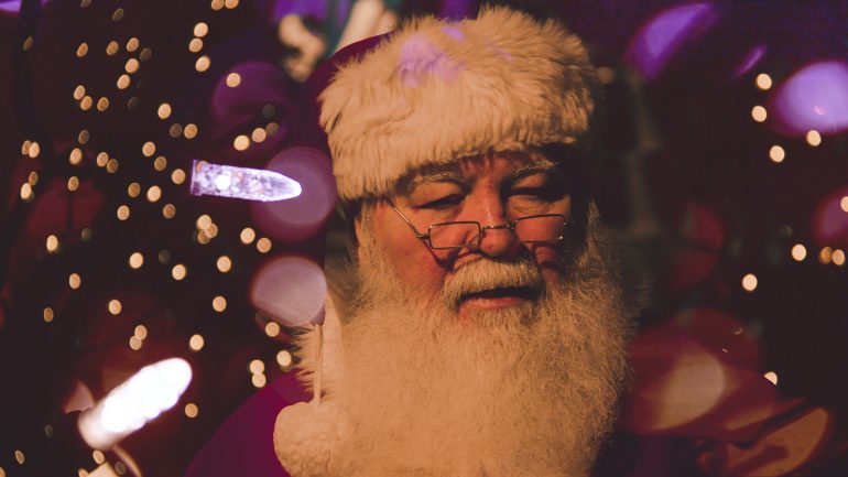 Santa science, santa standing within christmas lights